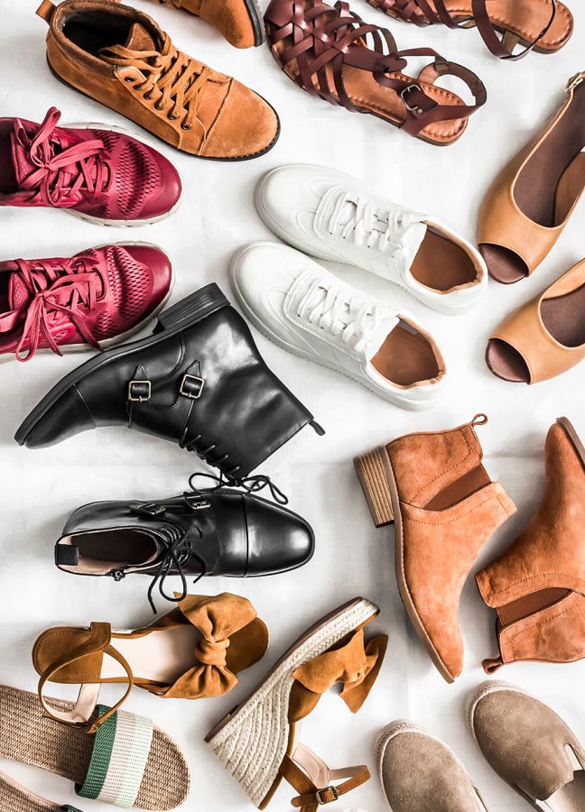 Variety of women's fashion comfortable shoes of all seasons on a light background, top view