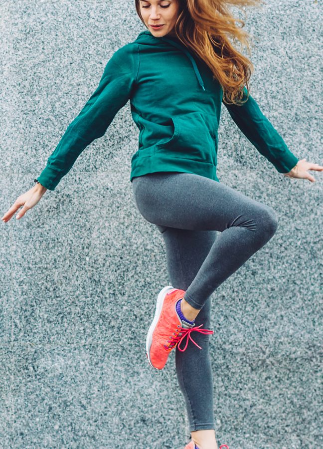 Fitness sport girl in fashion sportswear doing yoga fitness exercise in the street, outdoor sports, urban style